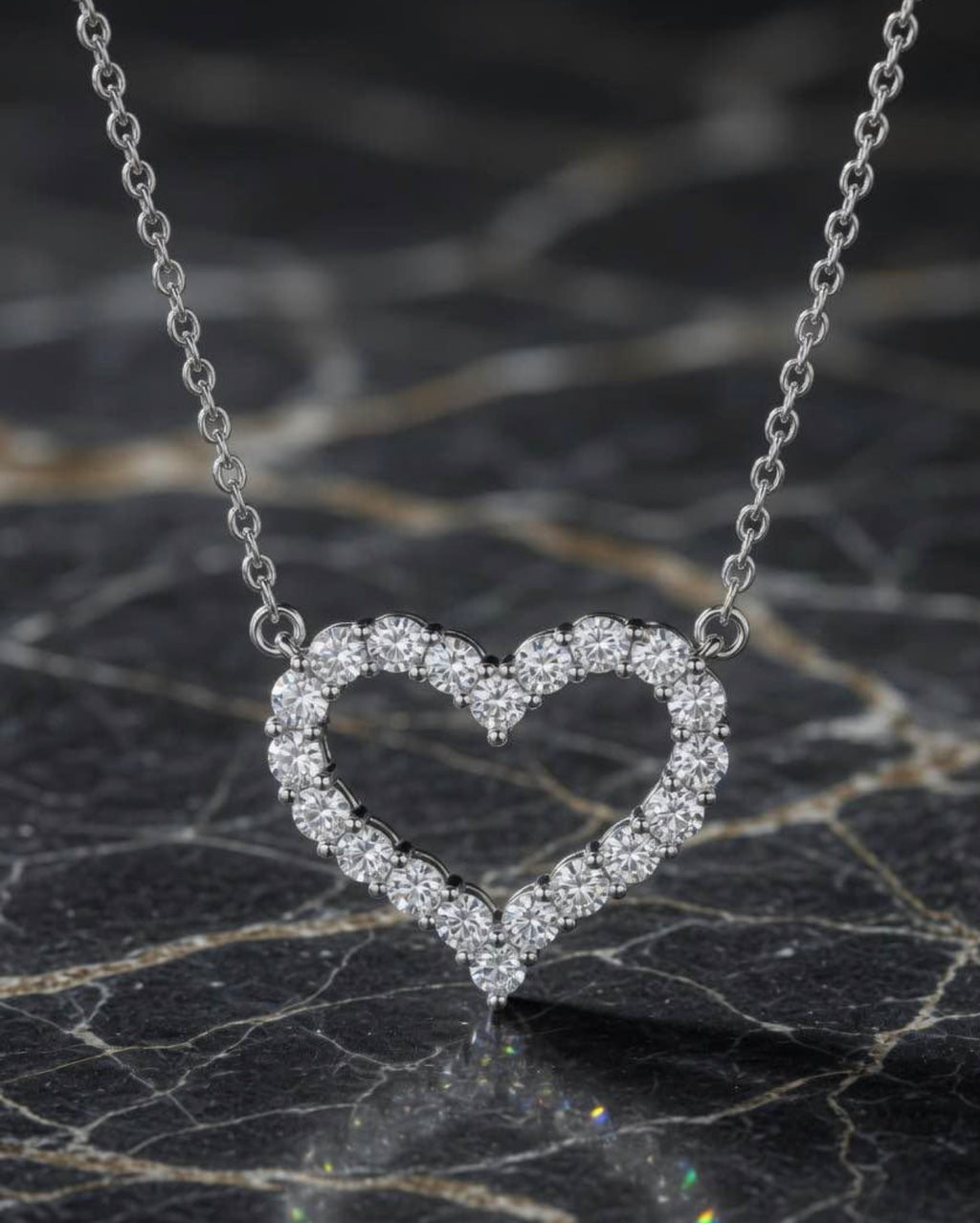 Diamond open heart necklace in 18K white gold on black marble
