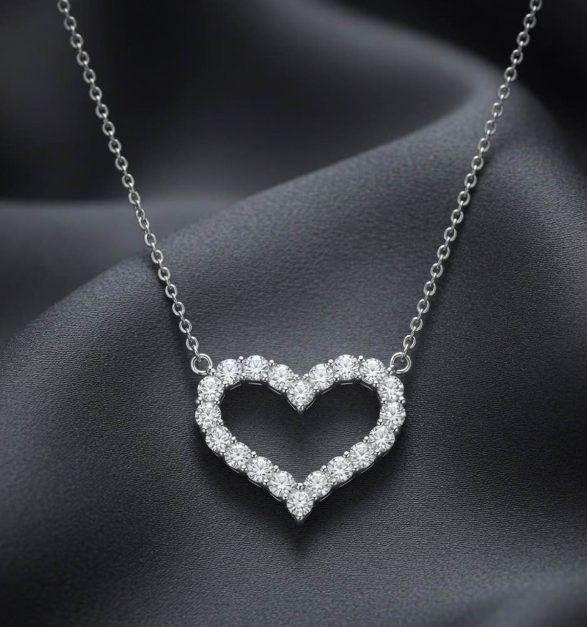 Diamond open heart necklace in 18K white gold on grey satin