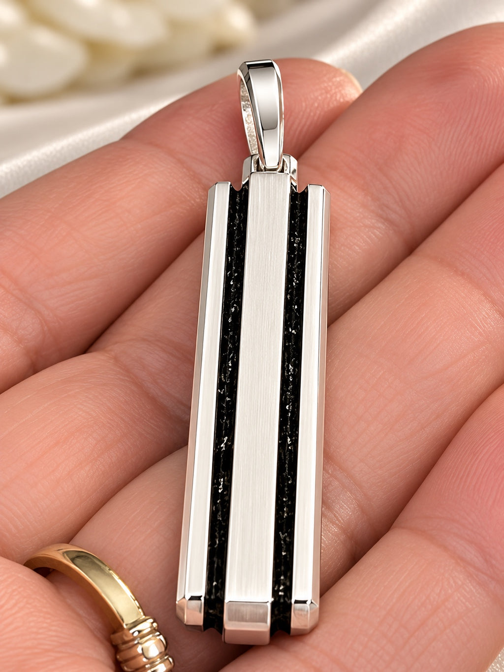 David Yurman men's rectangular pendant, held in hand