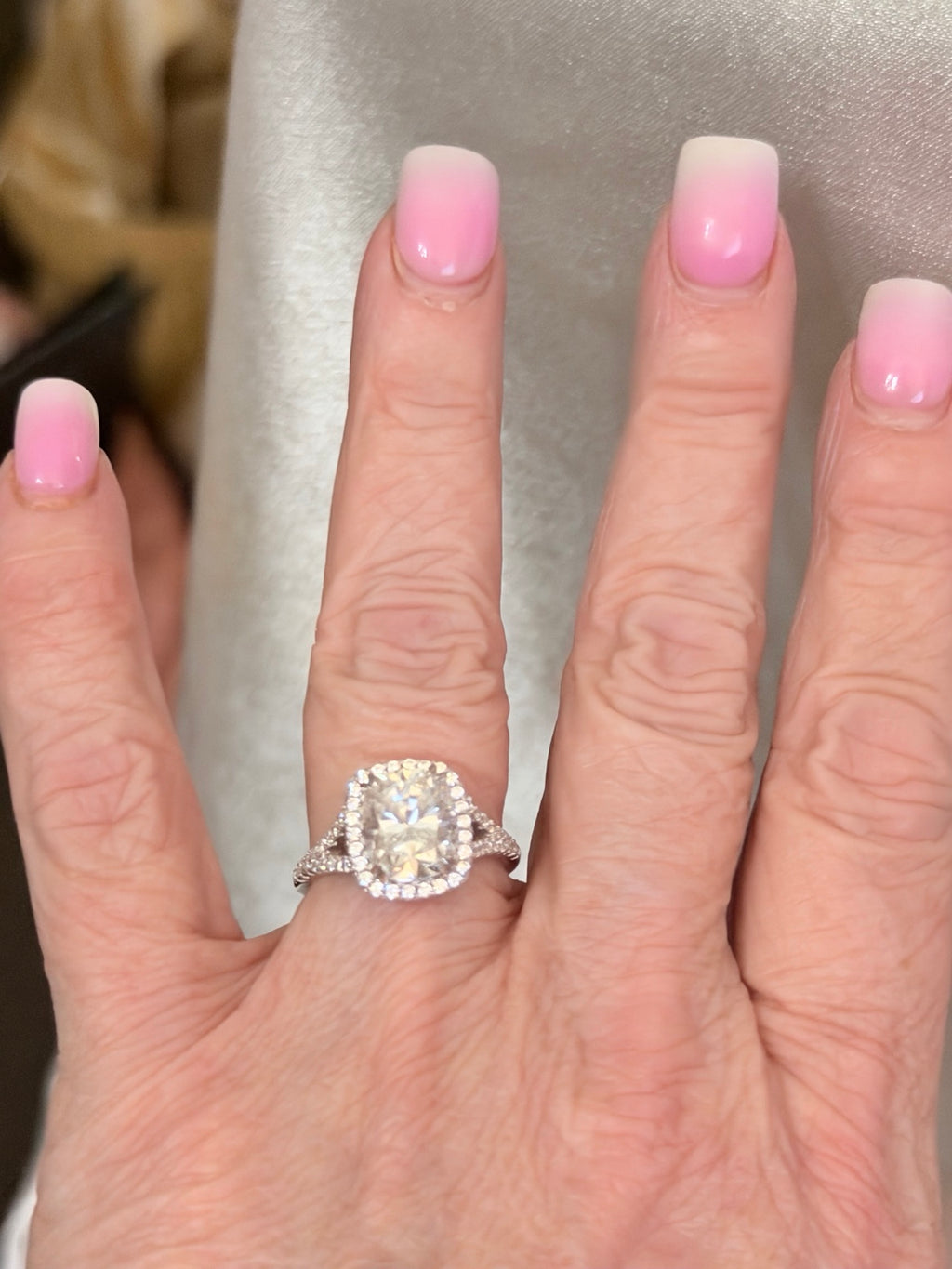 4 ct lab-grown diamond halo ring with platinum setting, worn on hand