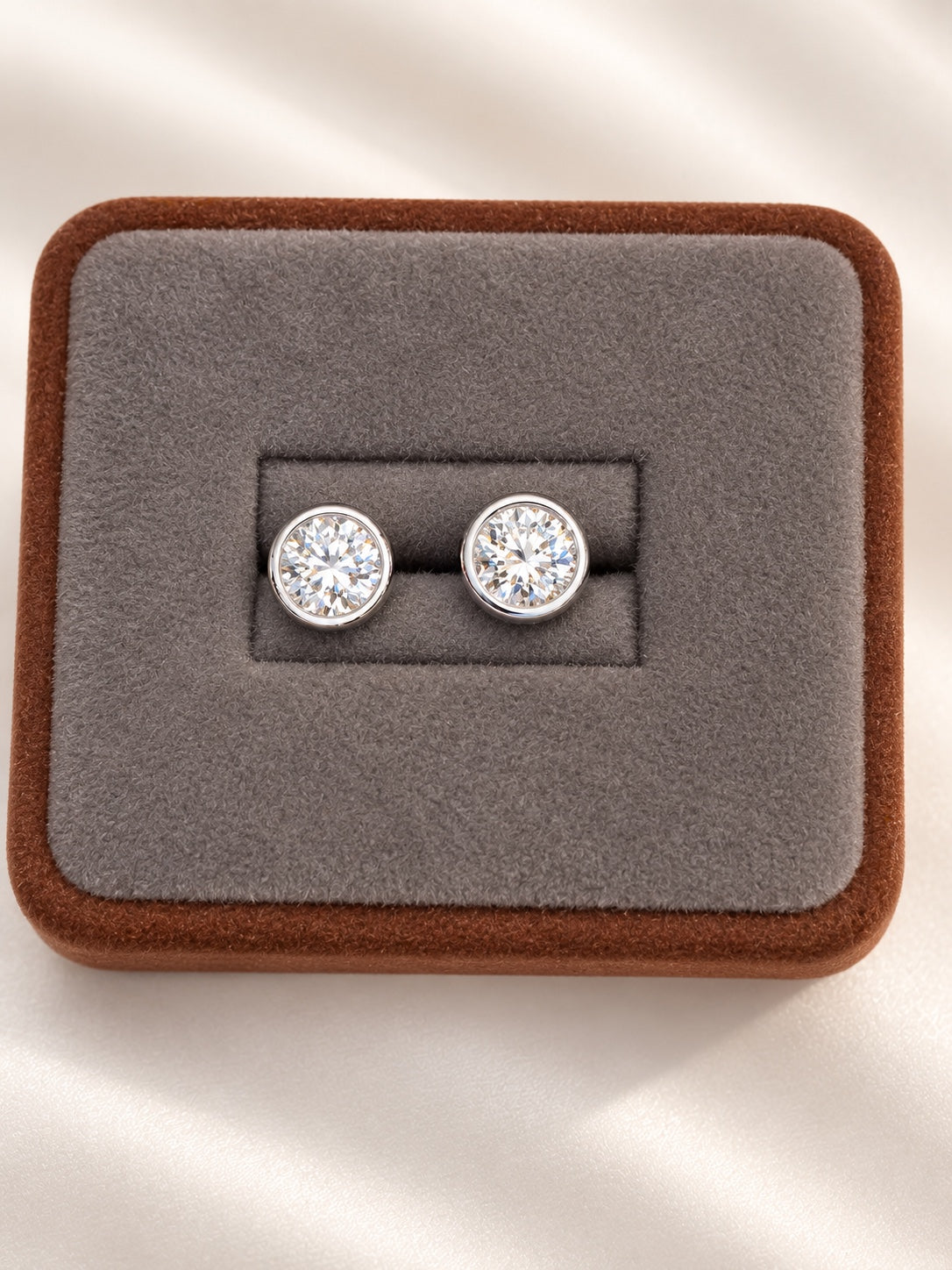 Round lab diamond stud earrings in 14K white gold bezel settings
