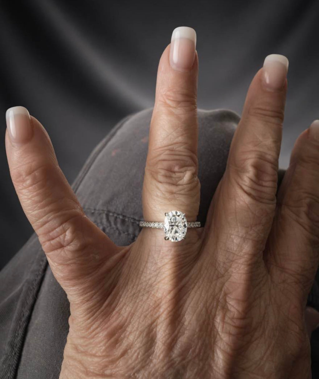 3 carat oval lab-grown diamond ring shown on hand
