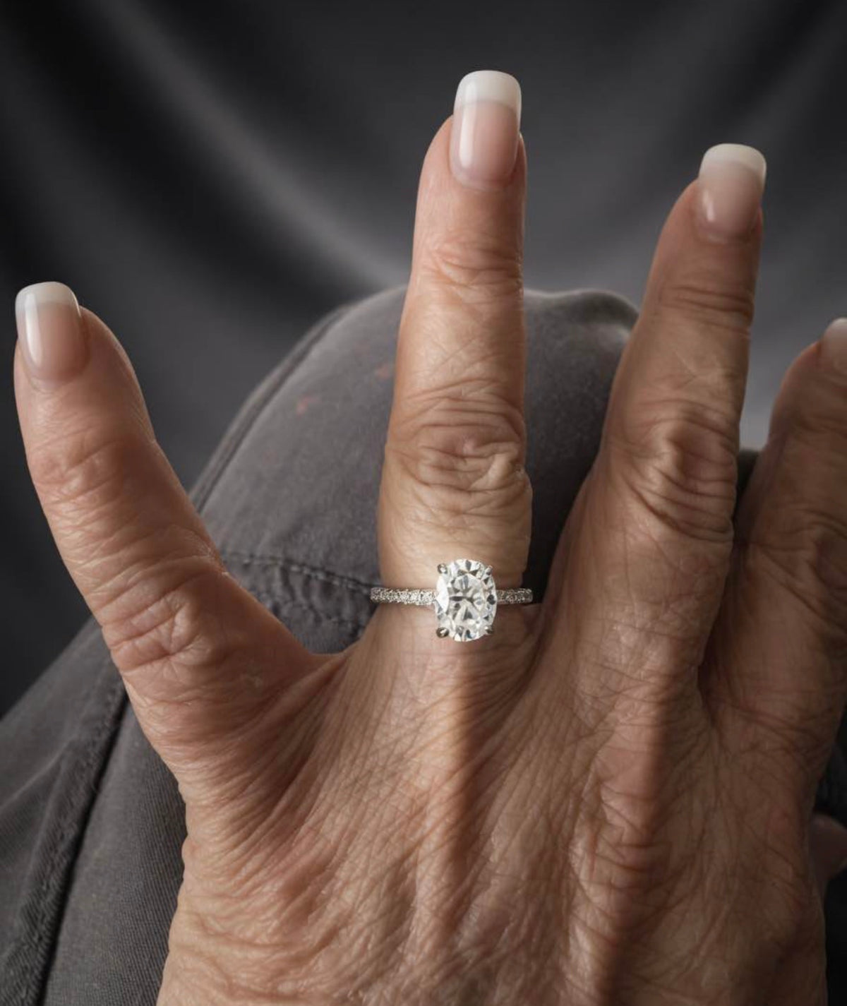 3 carat oval lab-grown diamond ring shown on hand