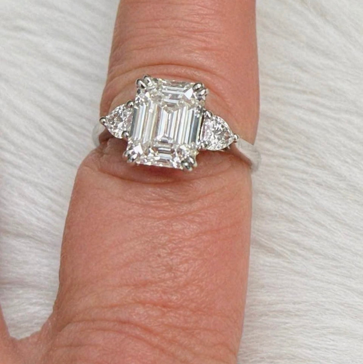 PHNX 3 carat emerald-cut center lab-grown diamond ring with half-carat side diamonds
