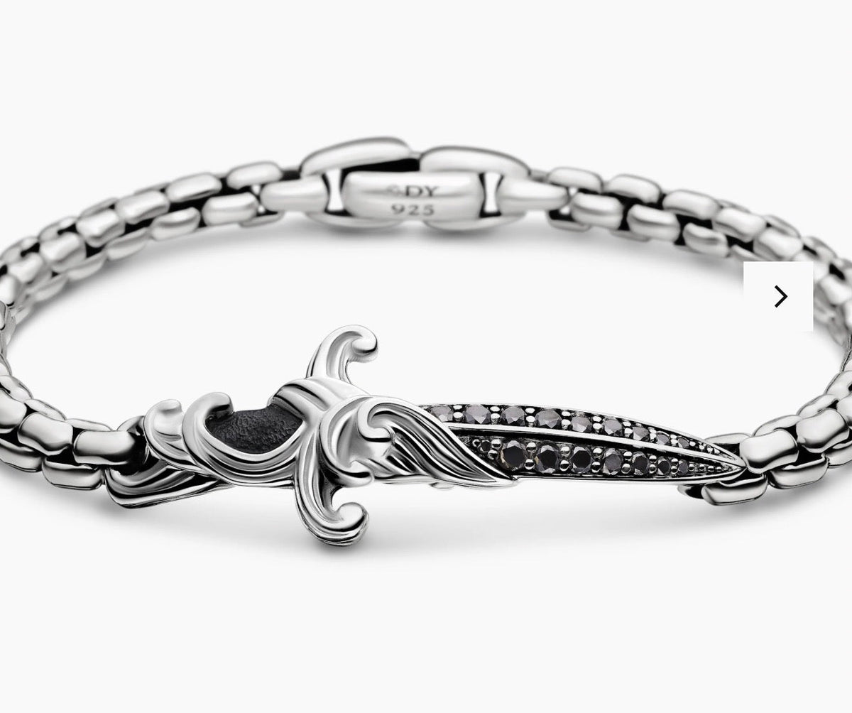 Close view of wave dagger bracelet, black diamonds, and 925 hallmark